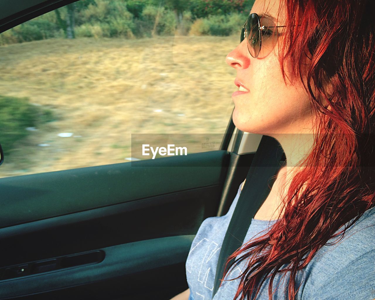 Close-up of woman wearing sunglasses in car