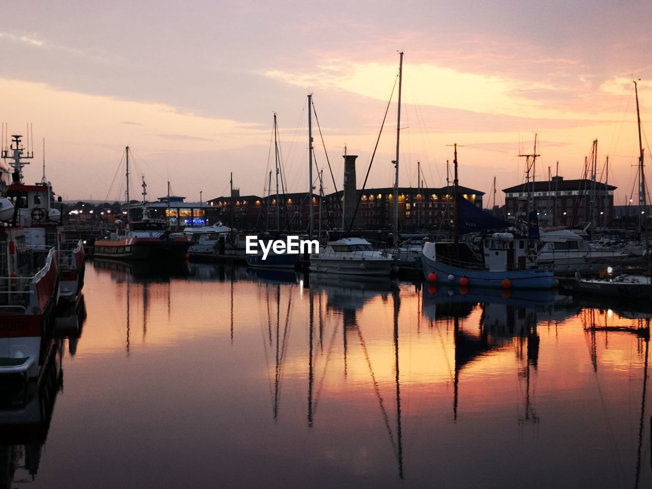 SAILBOATS IN HARBOR AT SUNSET