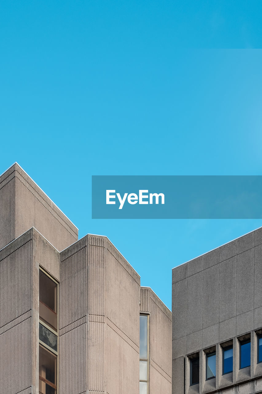 Low angle view of building against clear blue sky