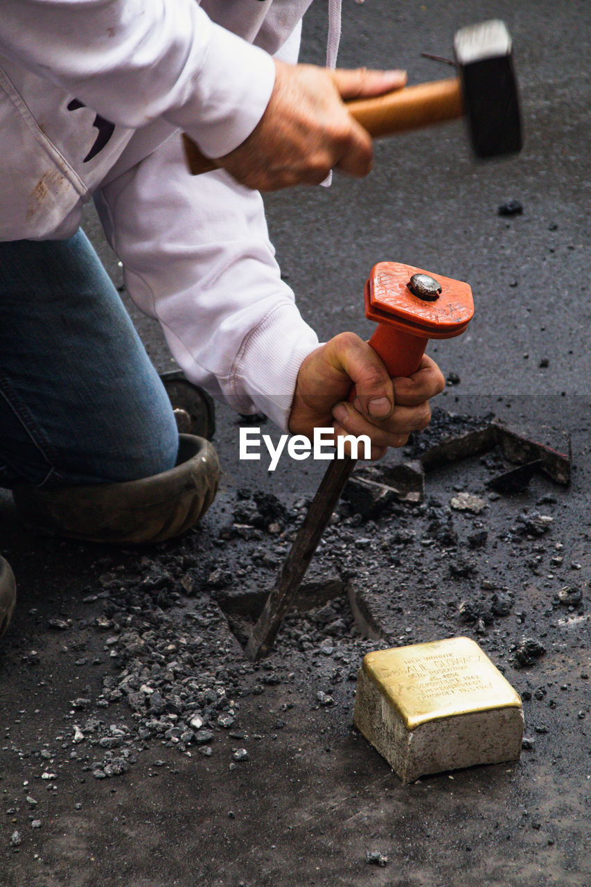 Low section of man working on barbecue grill