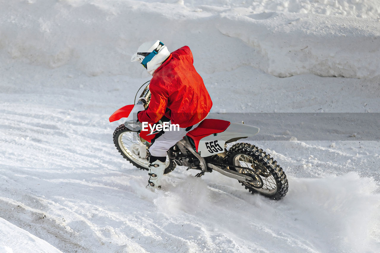 rear view of person skiing on snow covered field