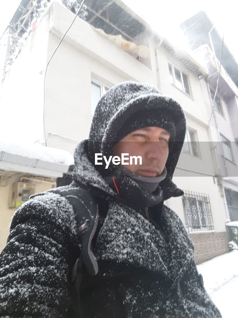 CLOSE-UP OF BOY WITH SNOW IN FOREGROUND