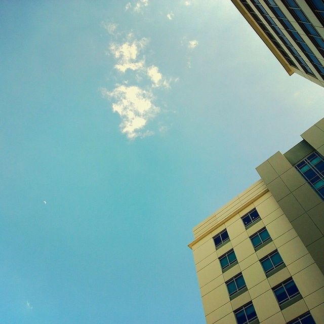 LOW ANGLE VIEW OF BUILDINGS AGAINST BLUE SKY