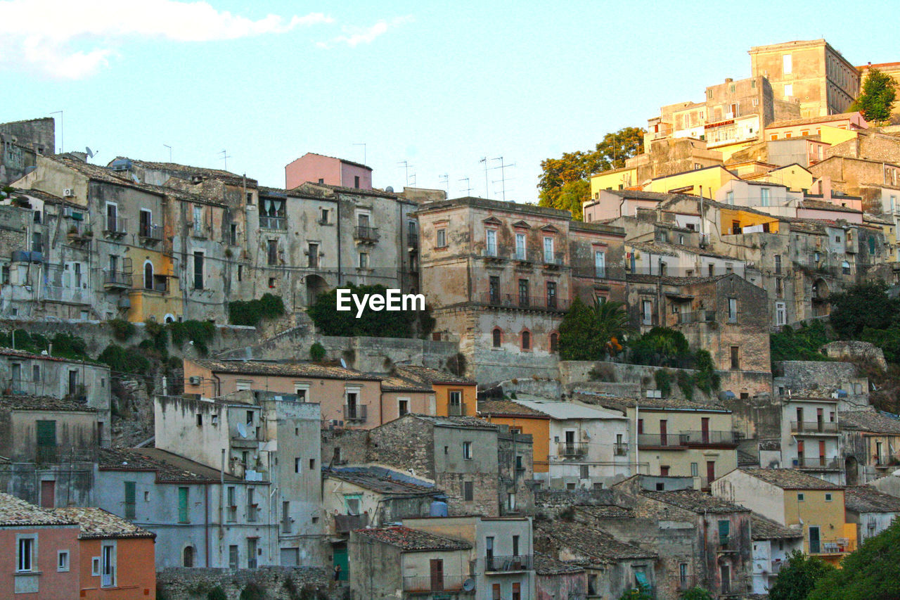 Buildings in town against sky