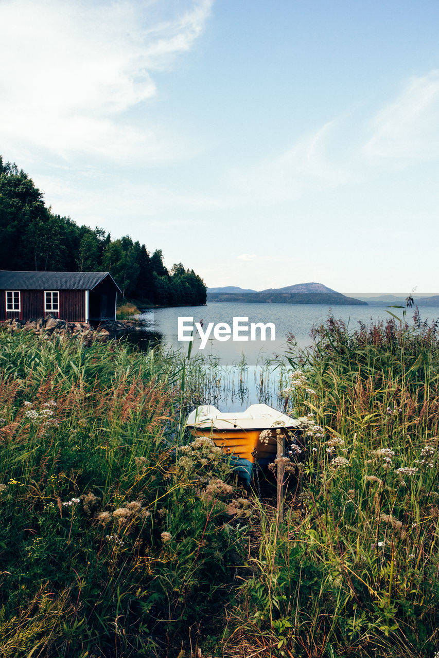 Scenic view of lake by building against sky