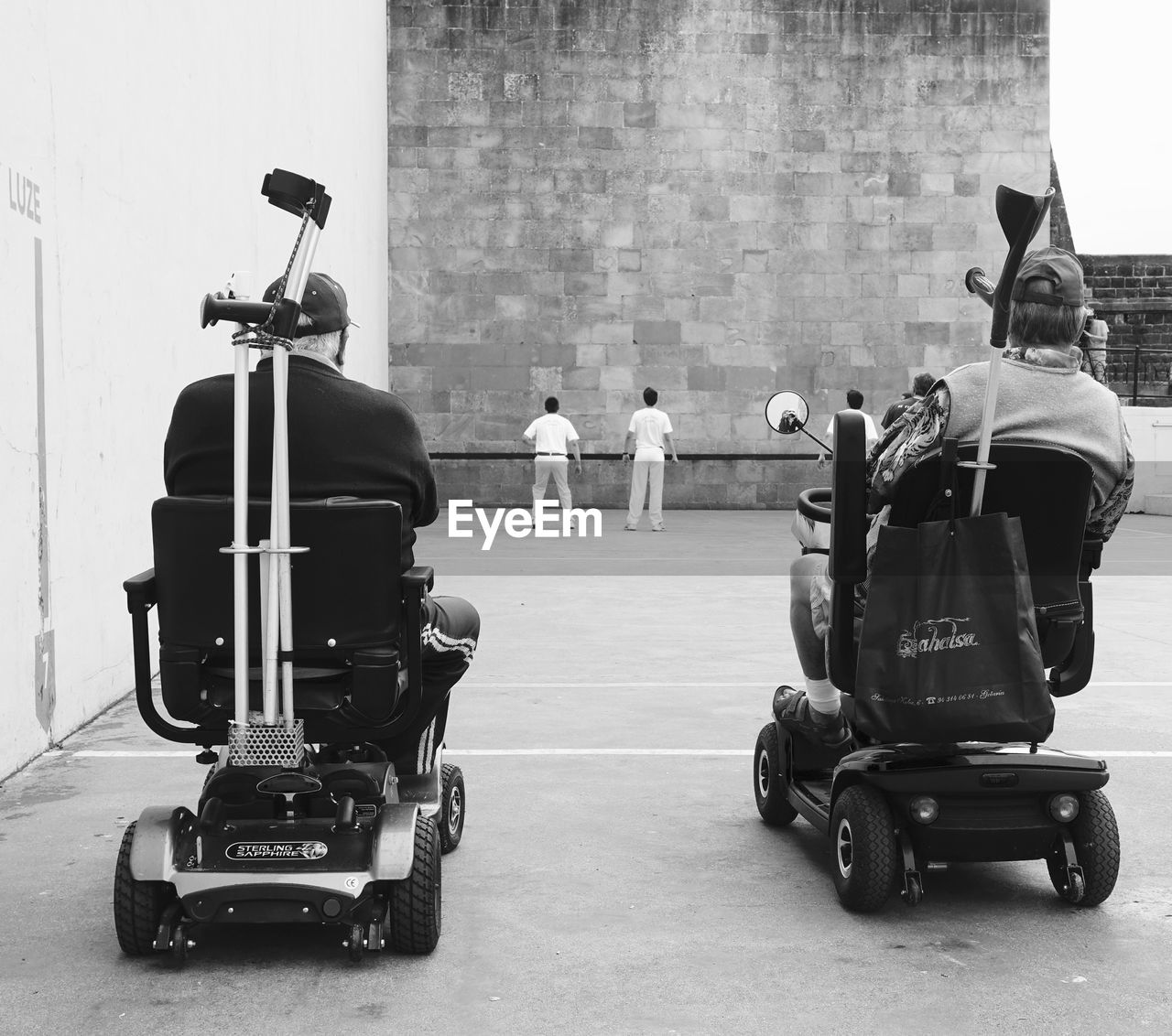 Rear view of men sitting in wheelchairs