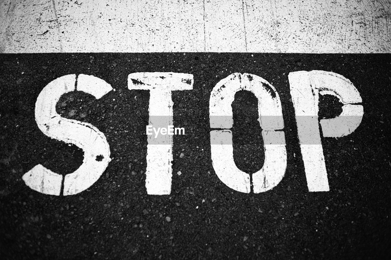 High angle view of arrow sign on road in city