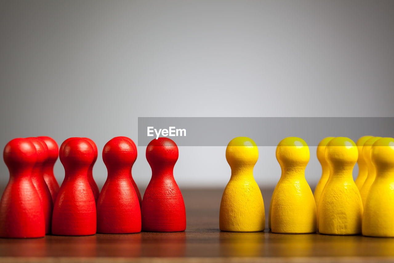 Close-up of tokens on table against gray background