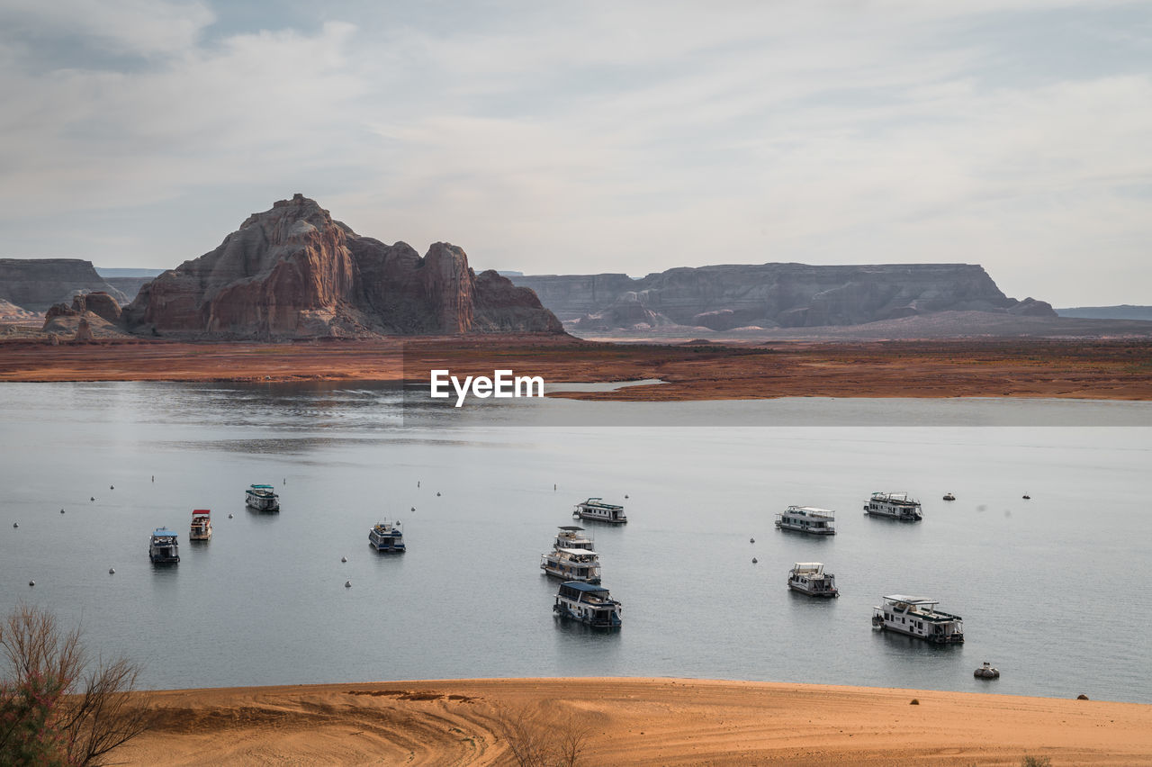 Houseboats on lake powell in warm morning light with nice clouds and reflections. zoomed in shot.