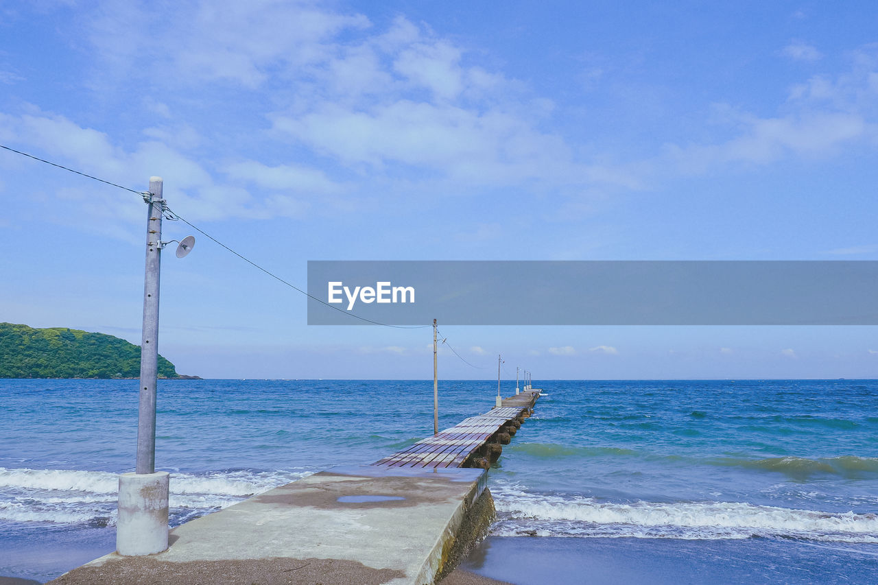 SCENIC VIEW OF BEACH AGAINST BLUE SKY