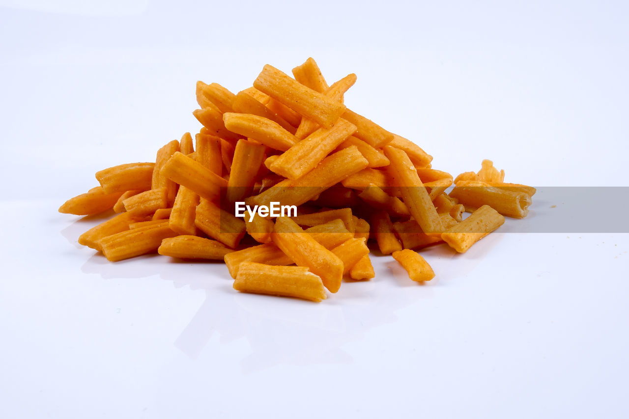 CLOSE-UP OF FOOD ON PLATE AGAINST WHITE BACKGROUND AGAINST GRAY