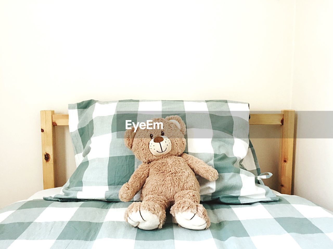 Teddy bear on bed at home