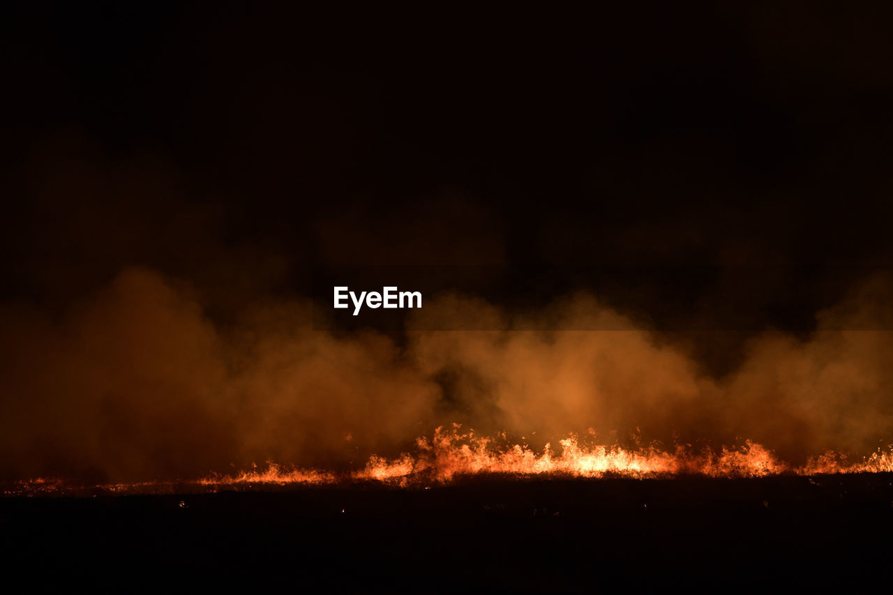 LOW ANGLE VIEW OF FIRE IN SKY