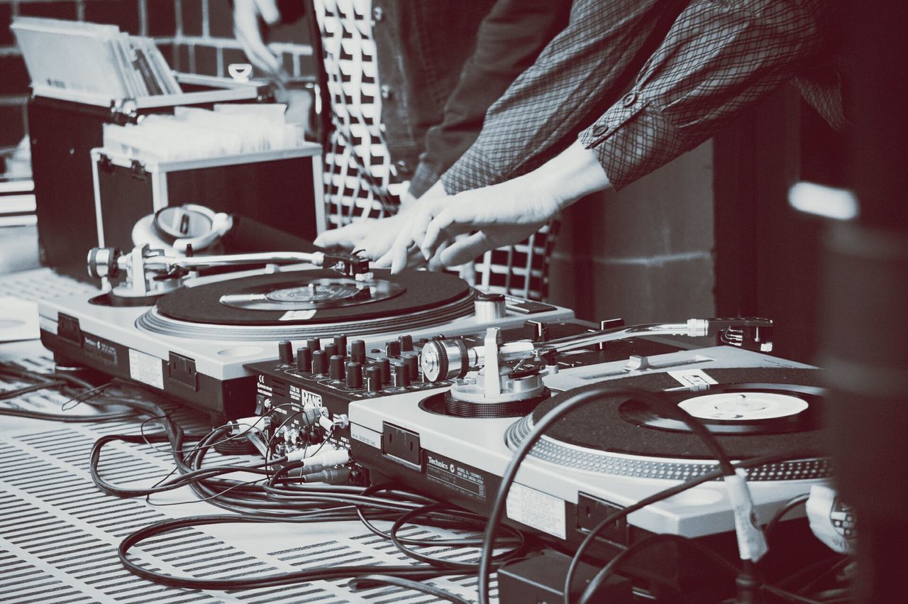 Two people using dj turntables