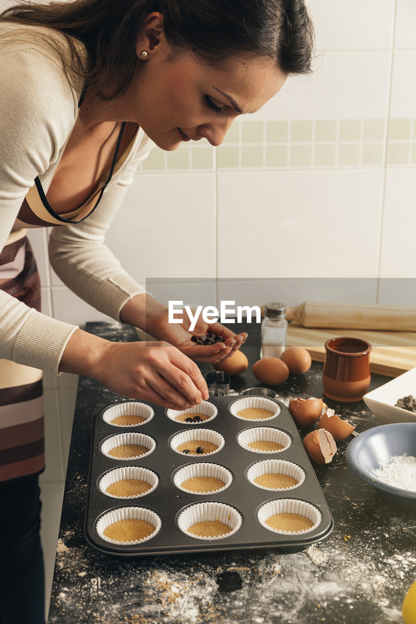 Woman making muffin at home