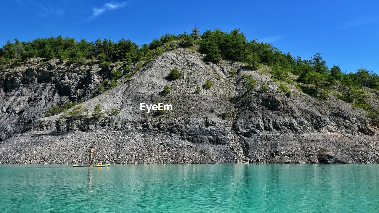 Scenic view of rocks in sea against sky