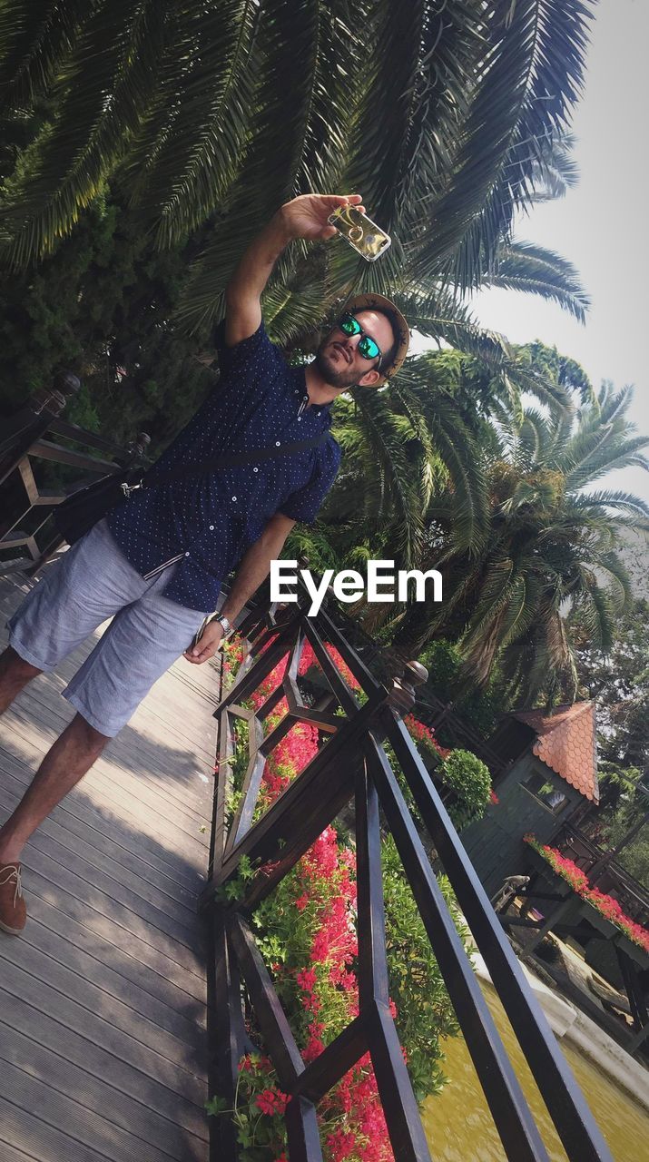 MAN PHOTOGRAPHING PLANTS