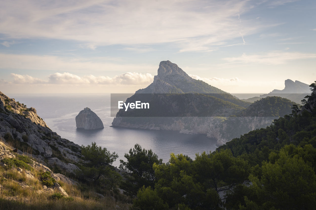 Scenic view of sea and mountains against sky