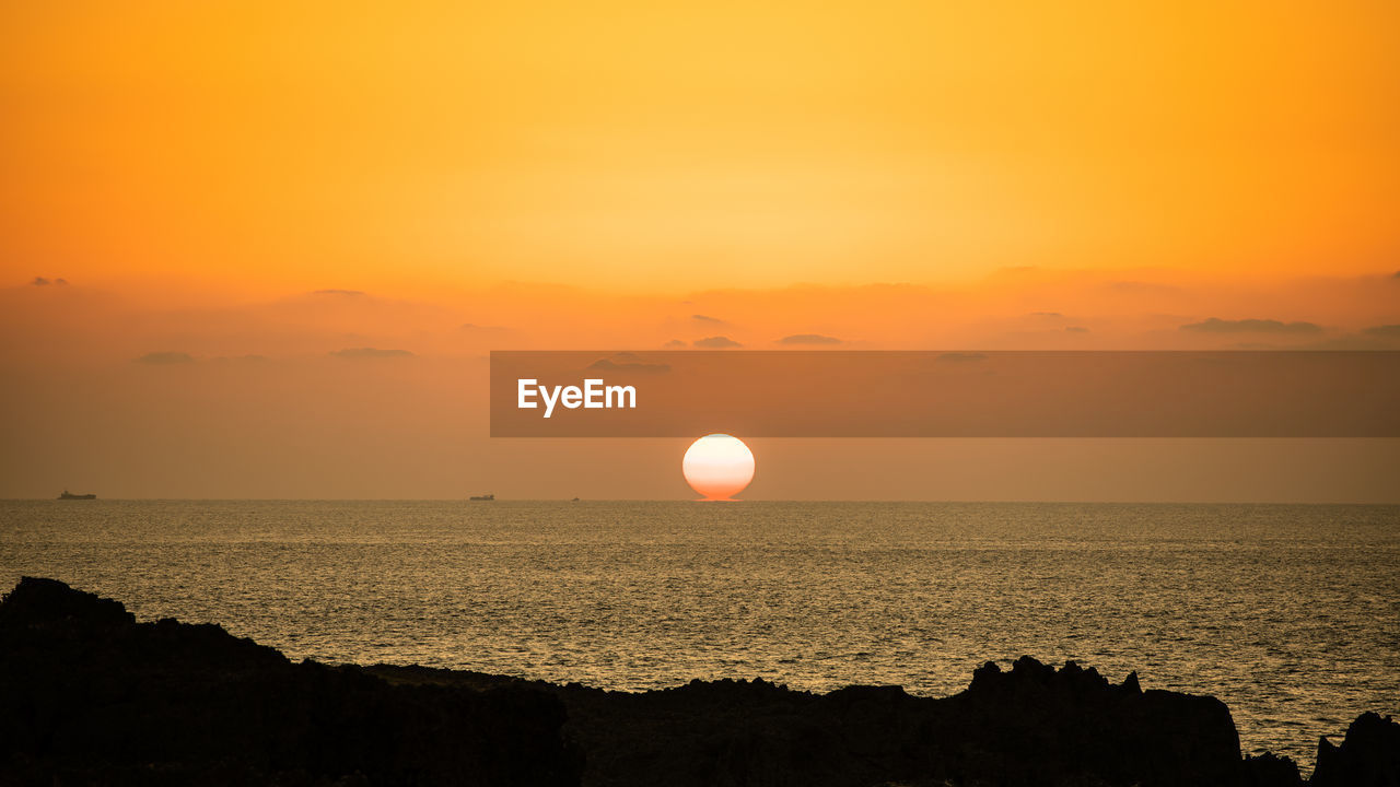 Scenic view of sea against sky during sunset