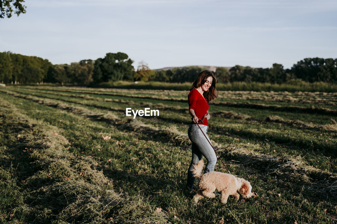 Woman walking with dog on land