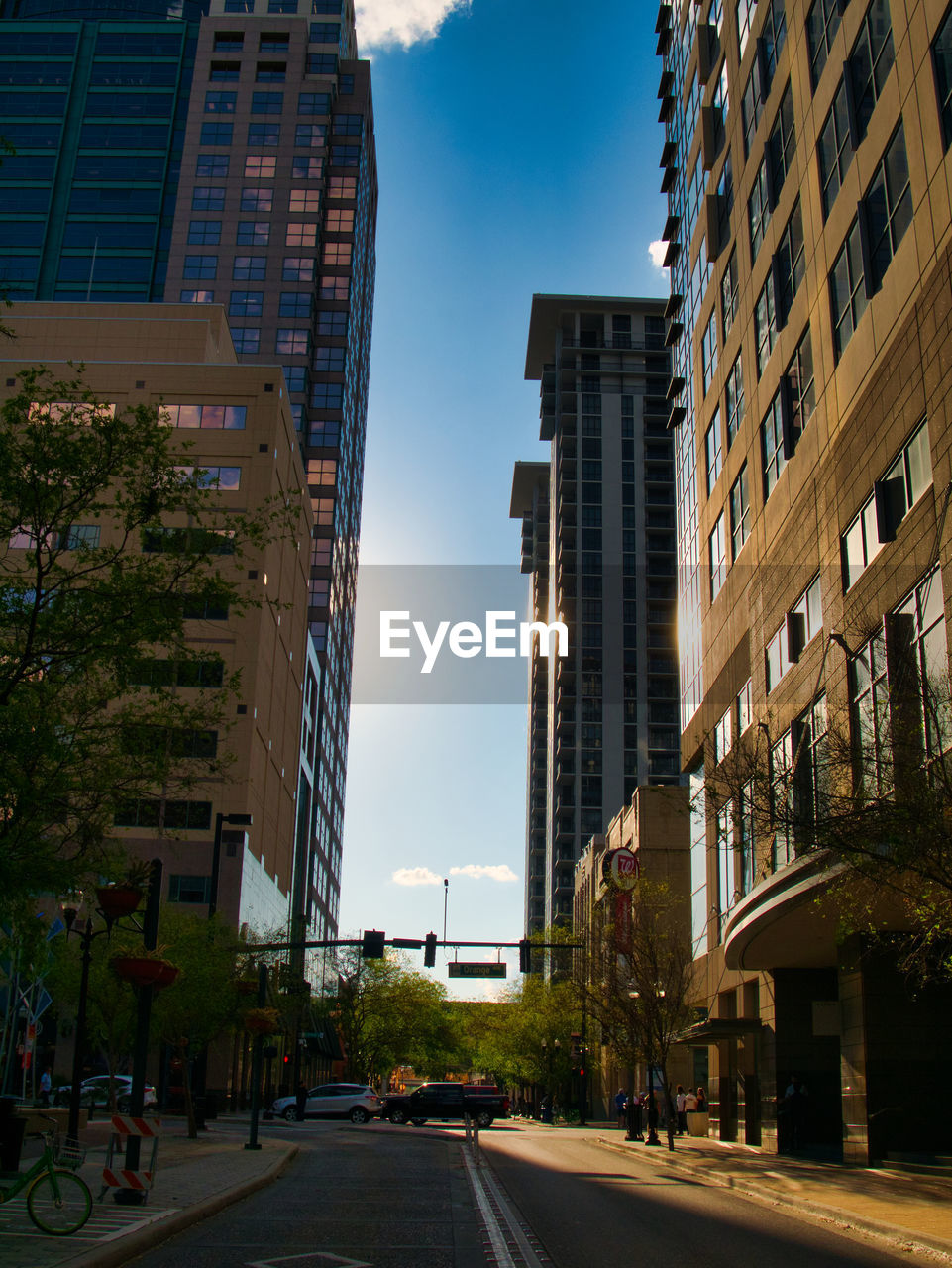 STREET AMIDST BUILDINGS AGAINST SKY