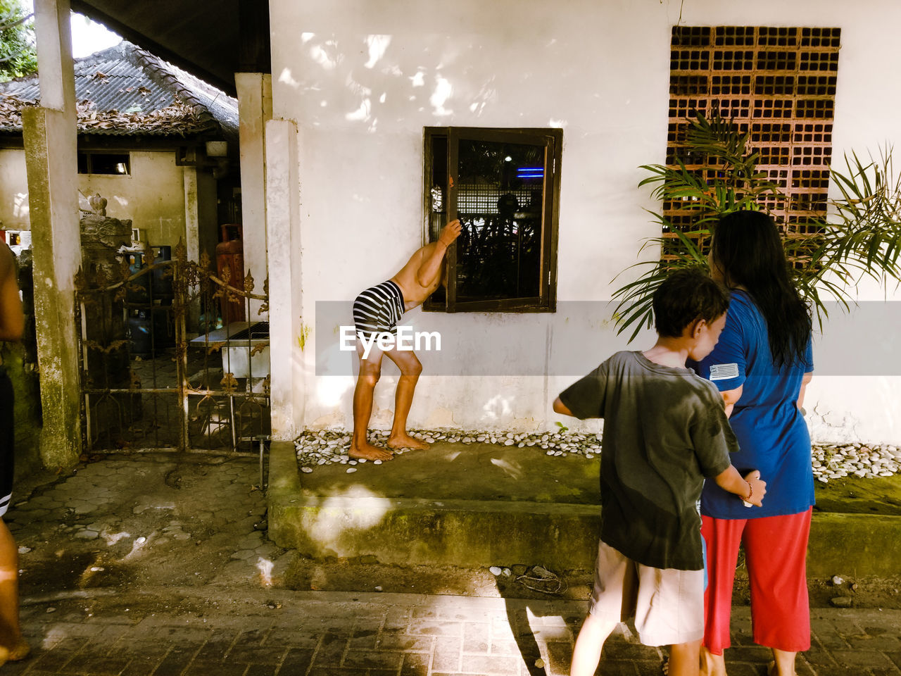 REAR VIEW OF FRIENDS STANDING ON THE FLOOR IN A AN ANIMAL