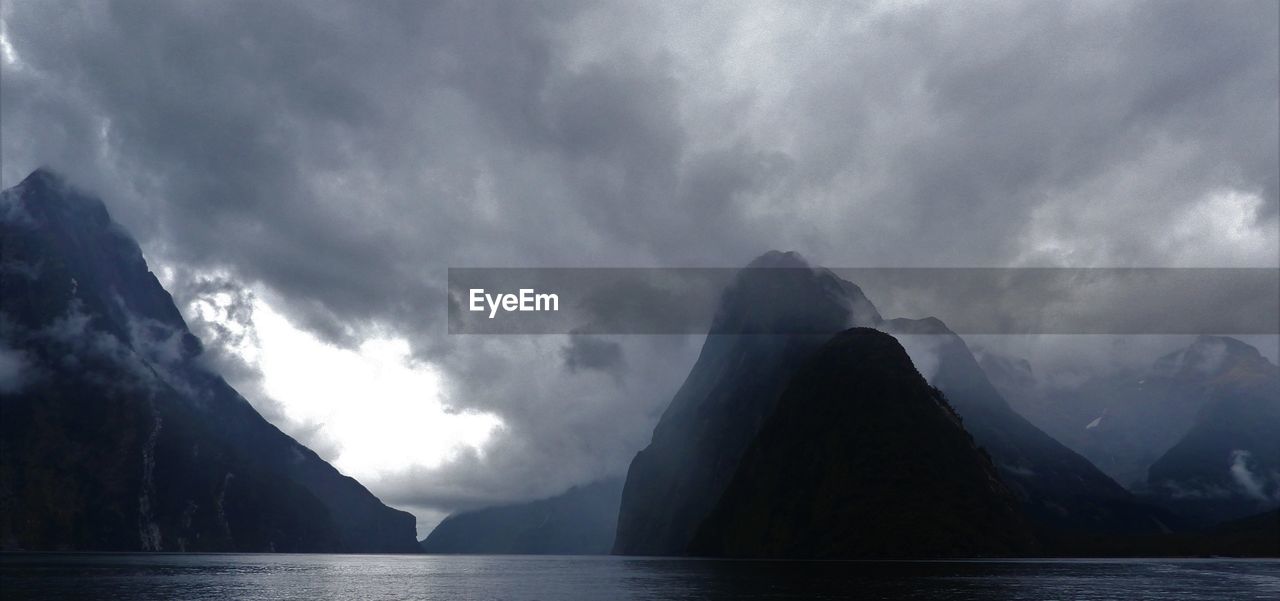 PANORAMIC SHOT OF SEA AND MOUNTAIN AGAINST SKY