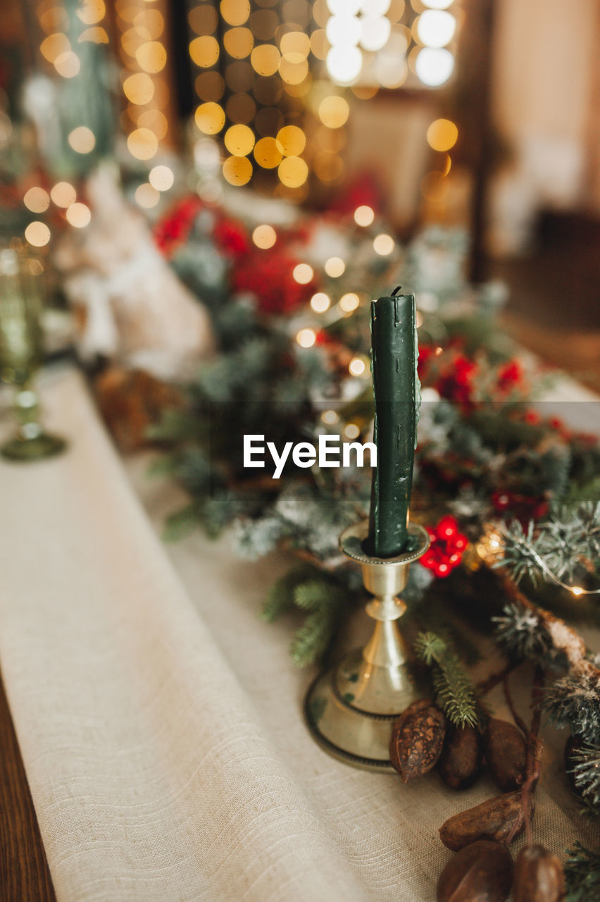 CLOSE-UP OF ILLUMINATED CHRISTMAS TREE ON TABLE