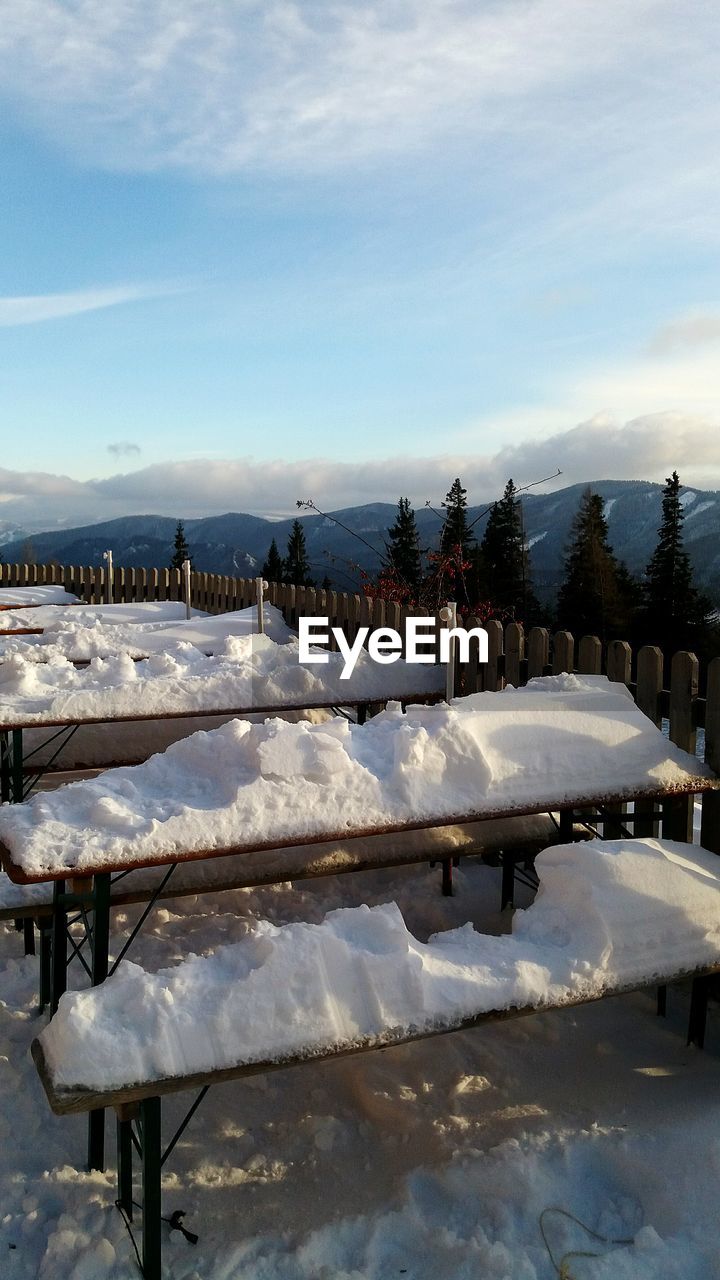 Snow covered landscape against sky