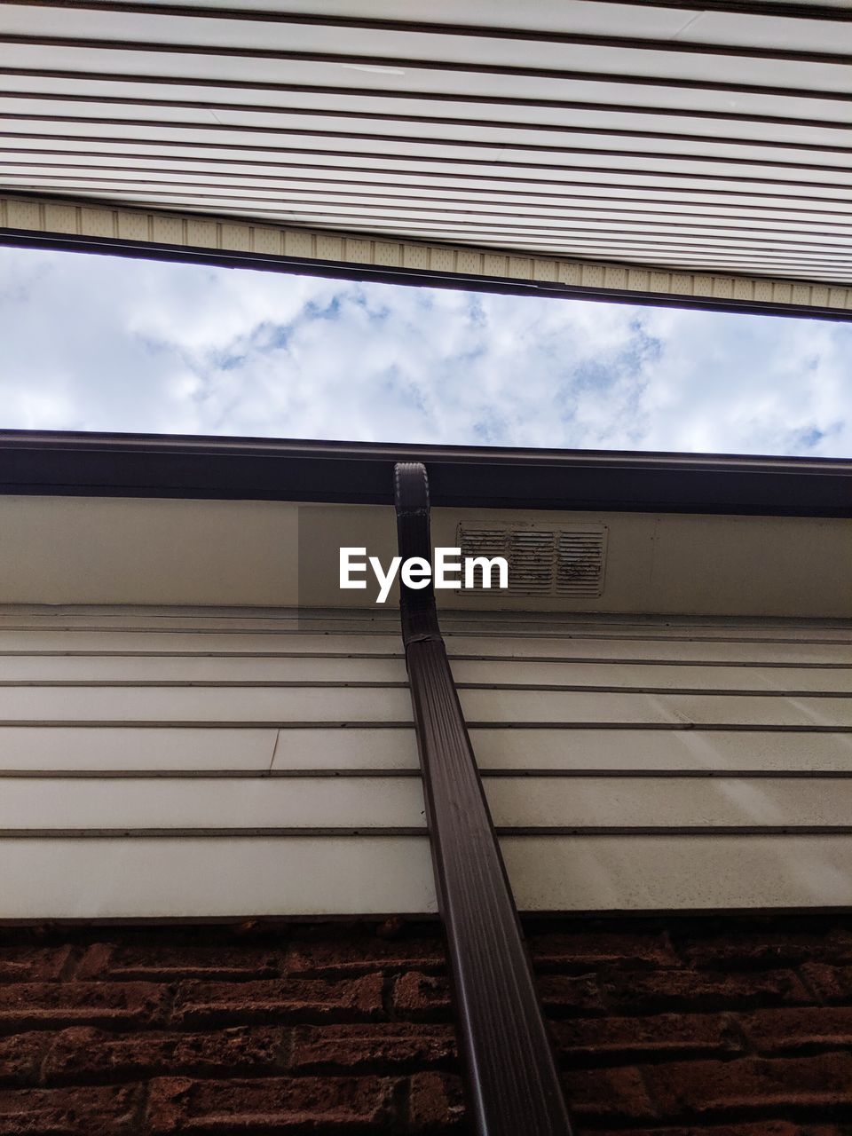 LOW ANGLE VIEW OF TEXT ON SHUTTER AGAINST SKY