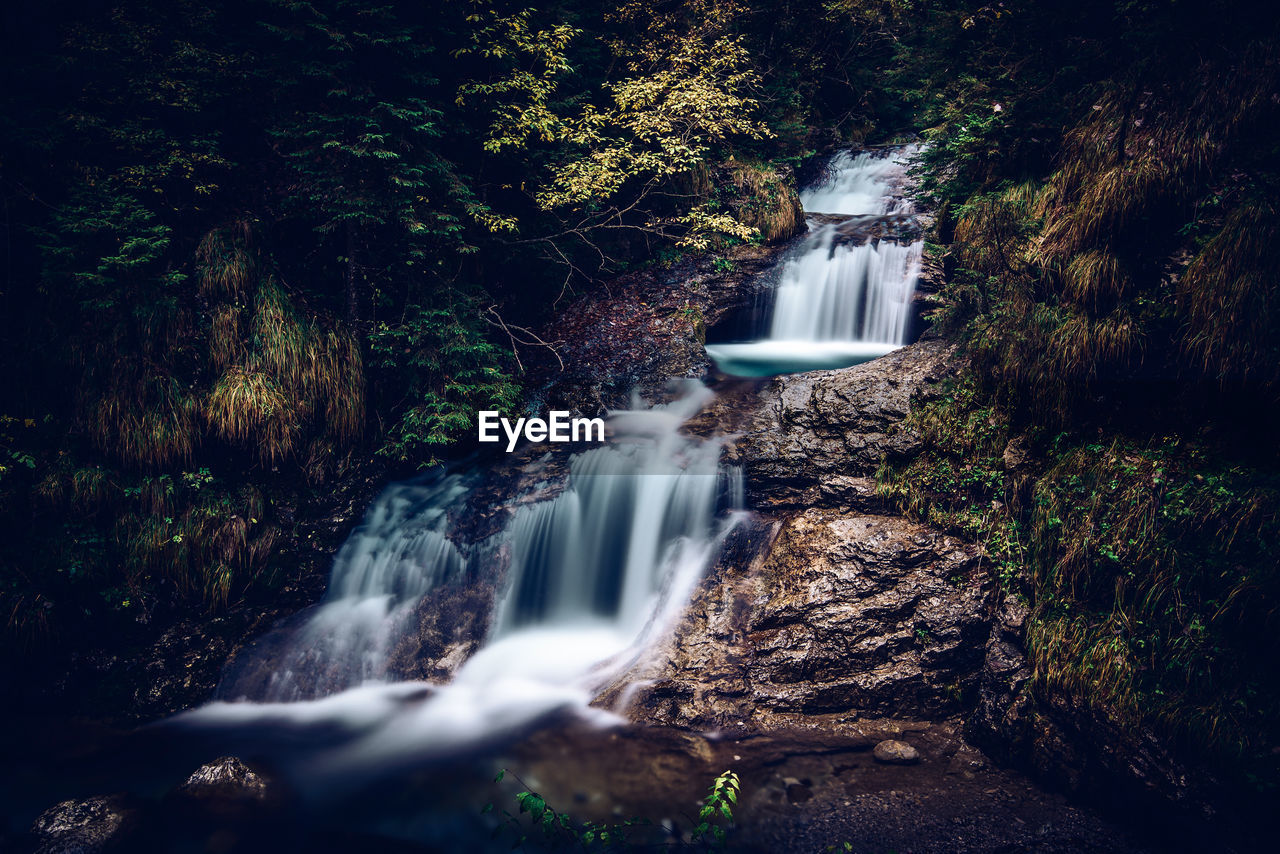 Relaxing flow of water in the enchanted valley italian alps landscape