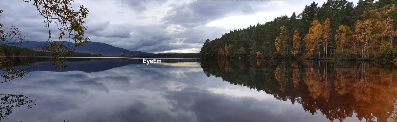 Panoramic view of lake and trees against sky