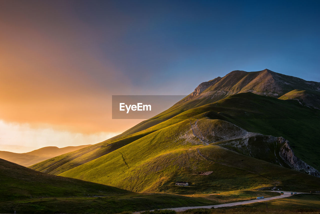 Scenic view of mountains against sky during sunset