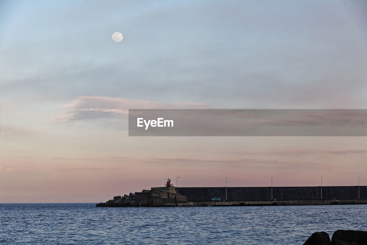 Scenic view of sea against sky at sunset