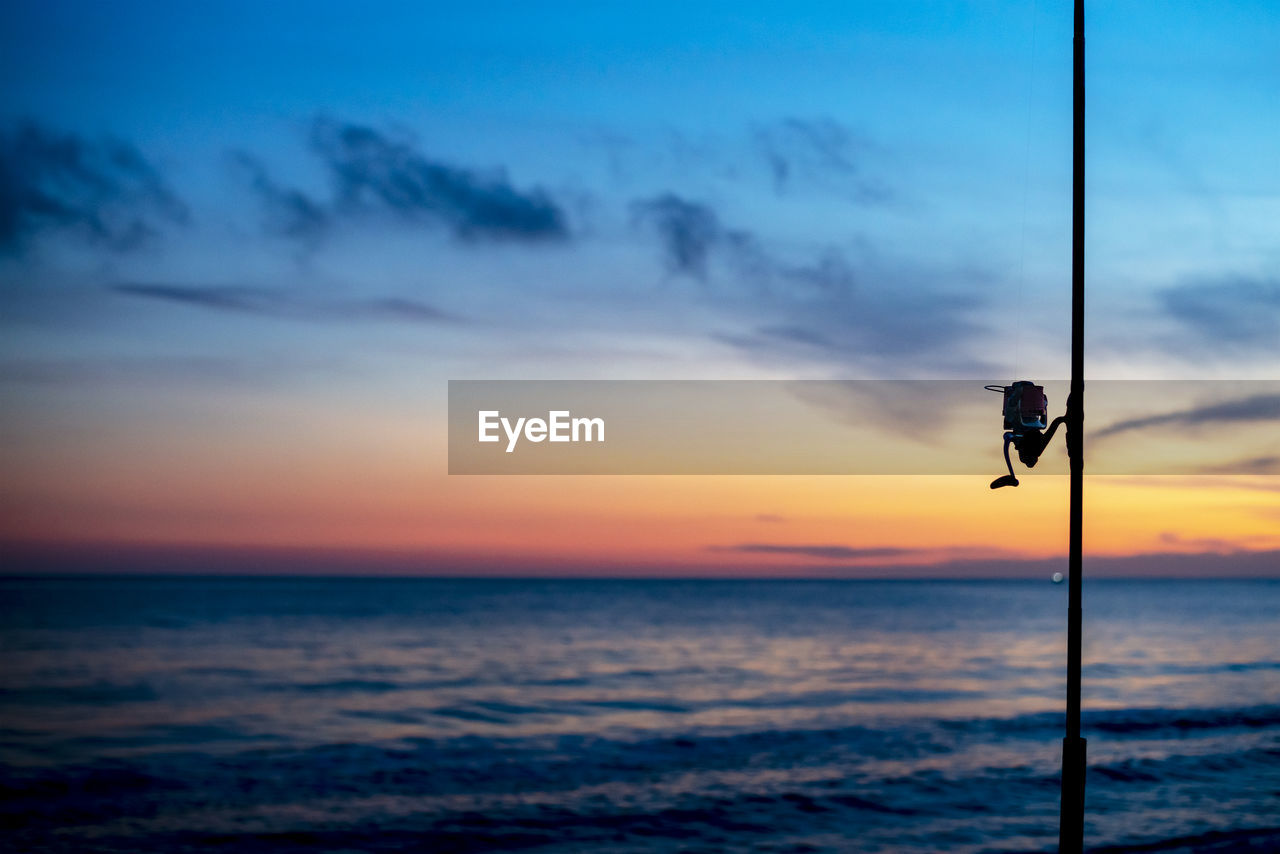 SCENIC VIEW OF SUNSET OVER SEA