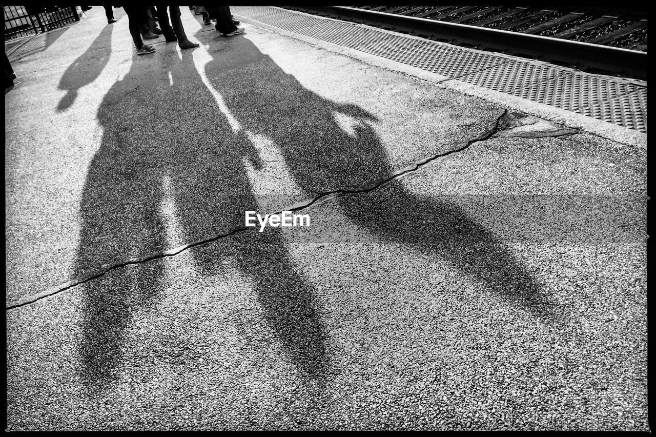 SHADOW OF PERSON ON ROAD