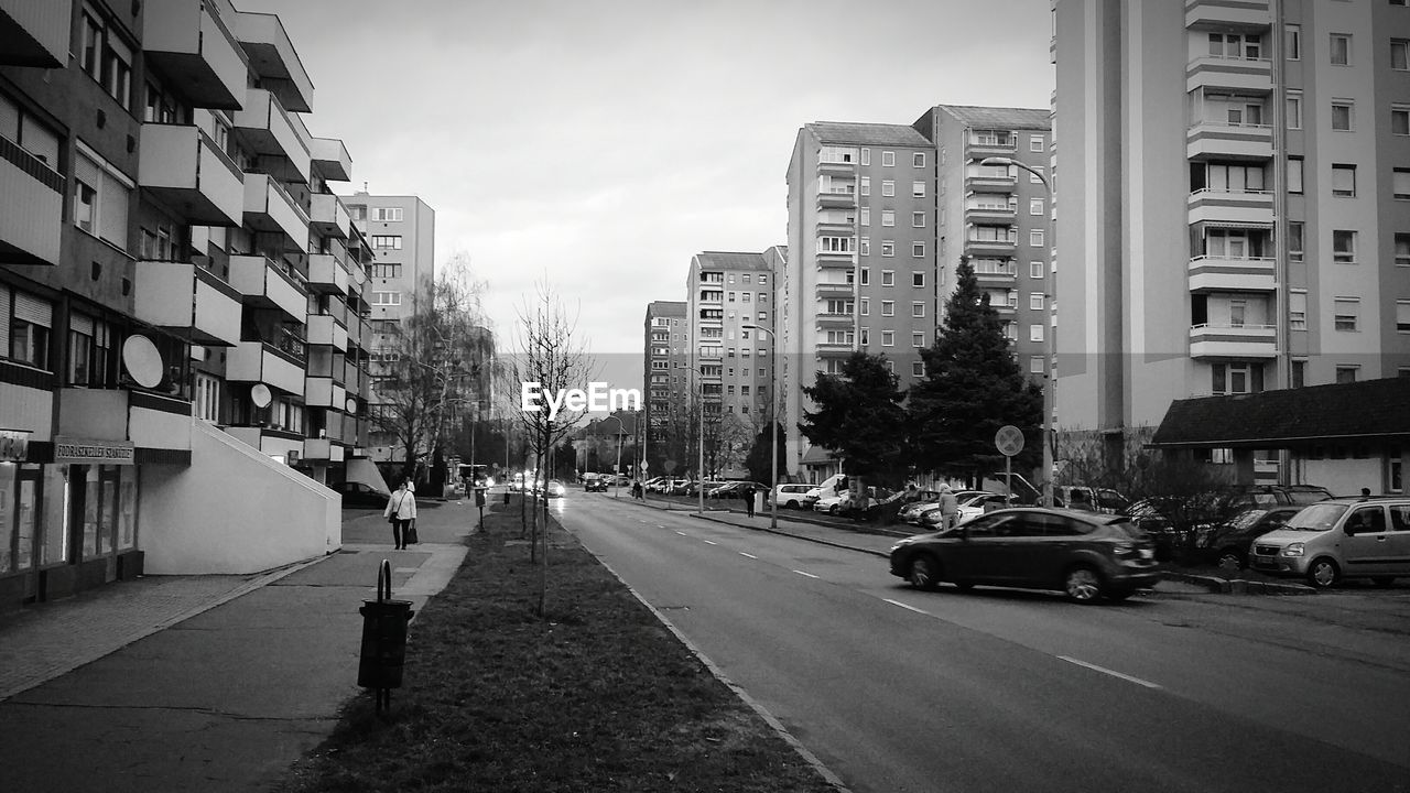 Cars on road amidst buildings in city