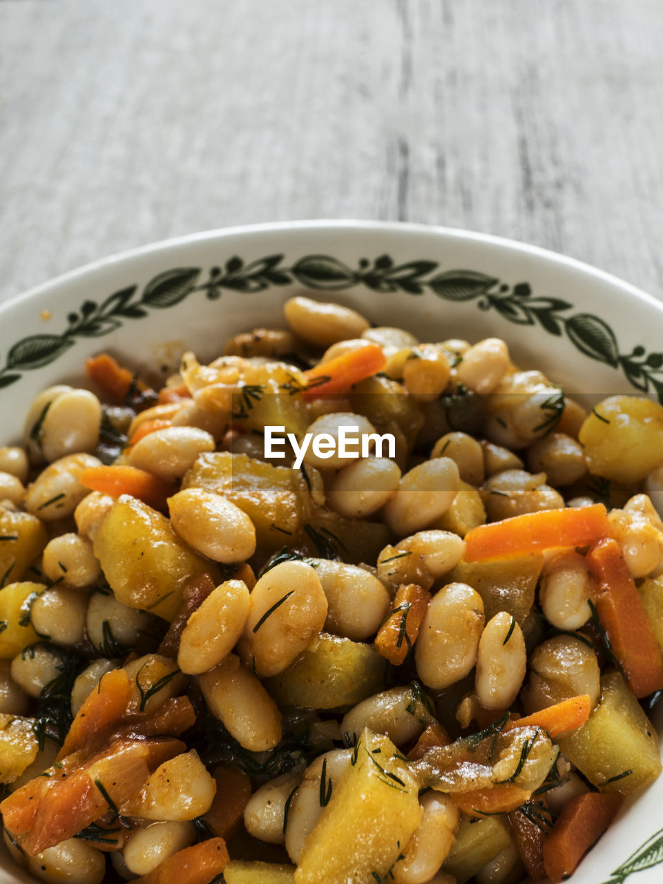 Close-up of baked beans in bowl on wooden table