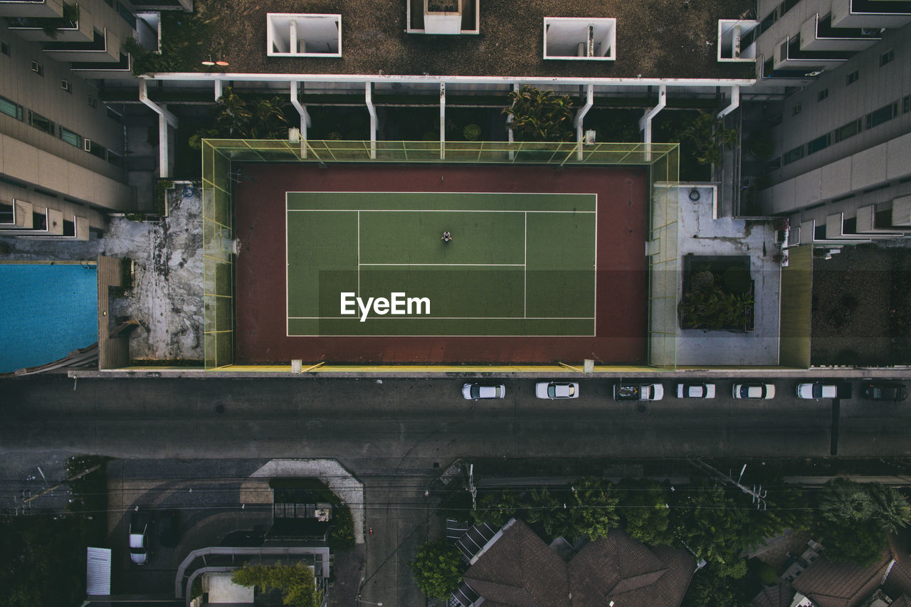 Directly above shot of tennis court amidst buildings in city