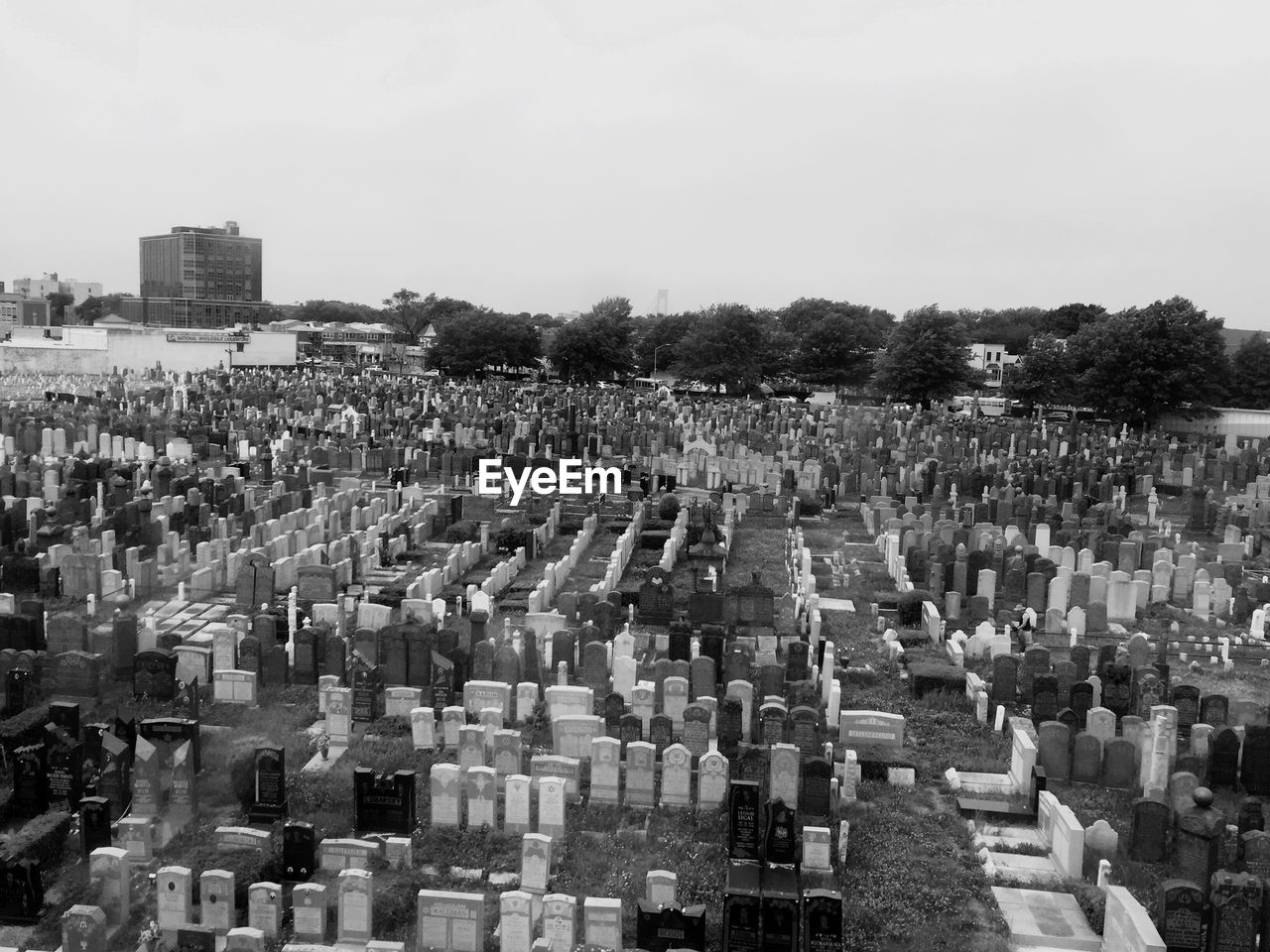 High angle view of tombstones in graveyard against sky