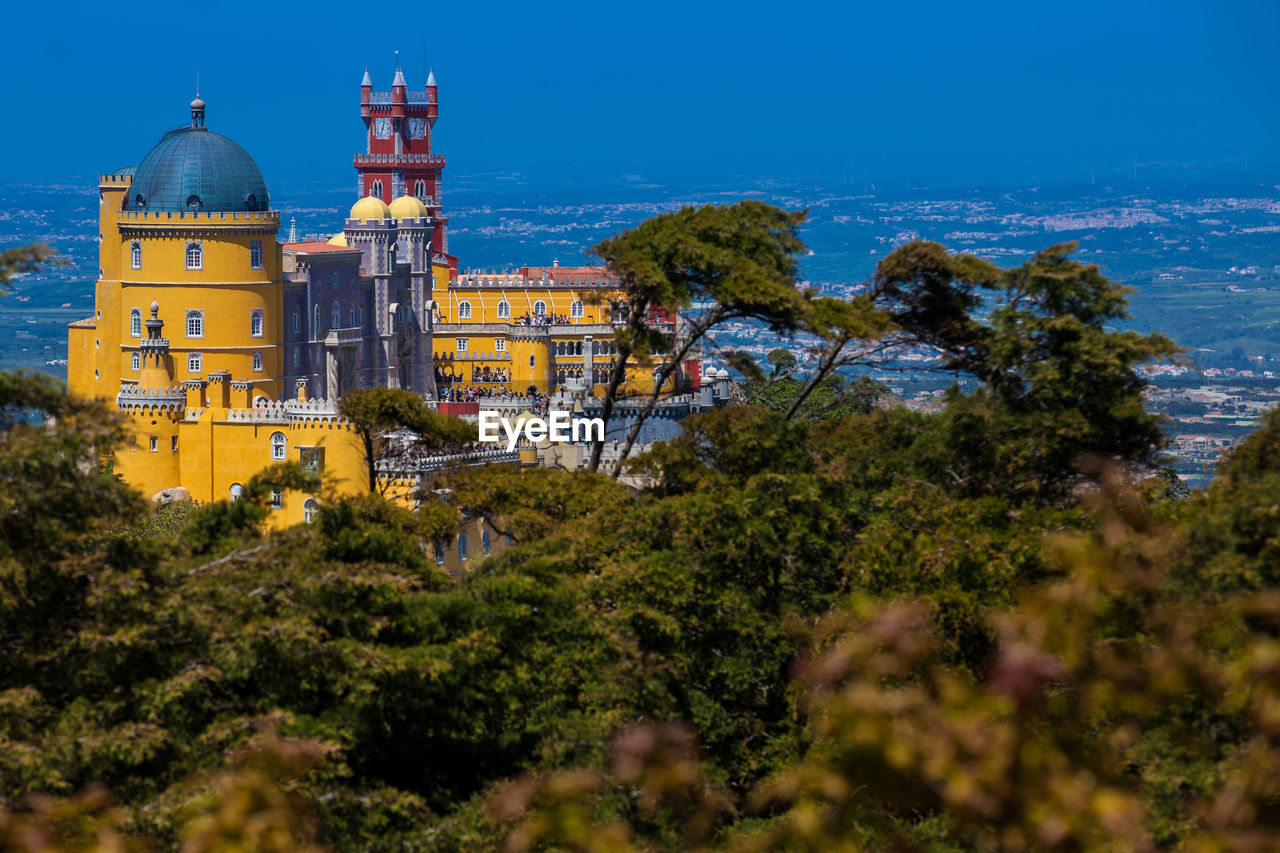 The pena palace seen from the gardens of pena park at the municipality of sintra
