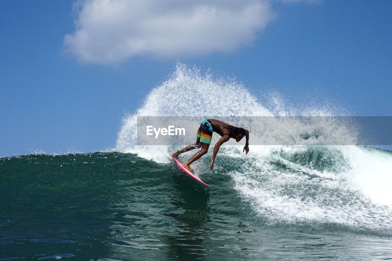 Man surfing on sea against sky