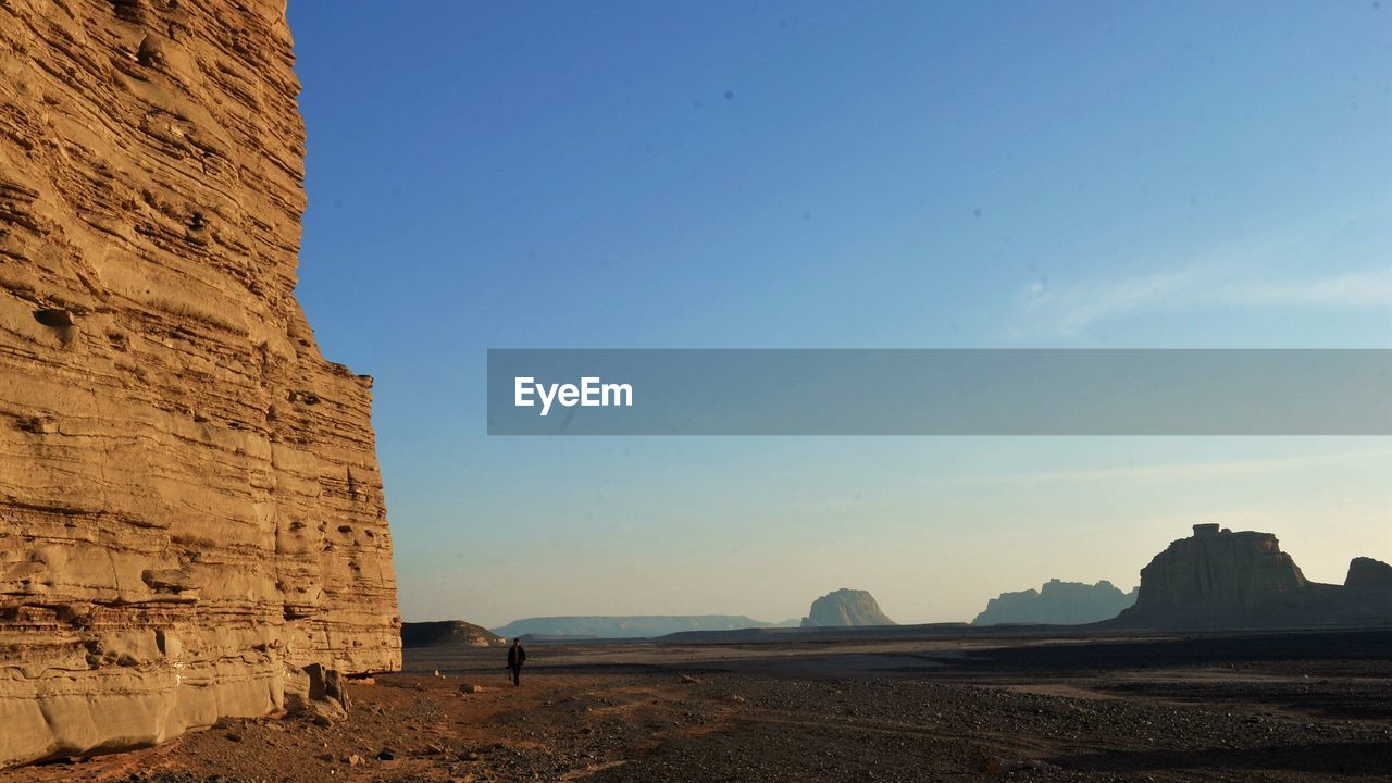 Scenic view of cliff against clear sky