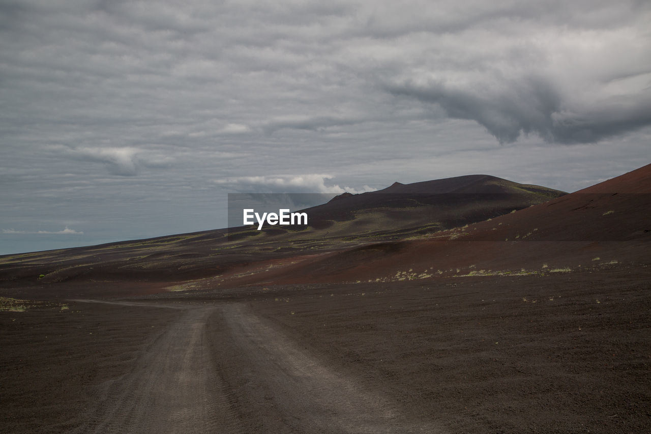 Empty road along countryside landscape