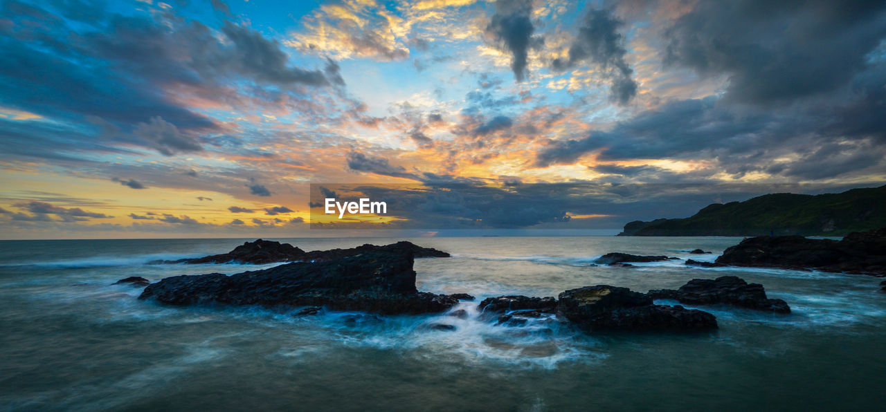 Scenic view of sea against sky at sunset