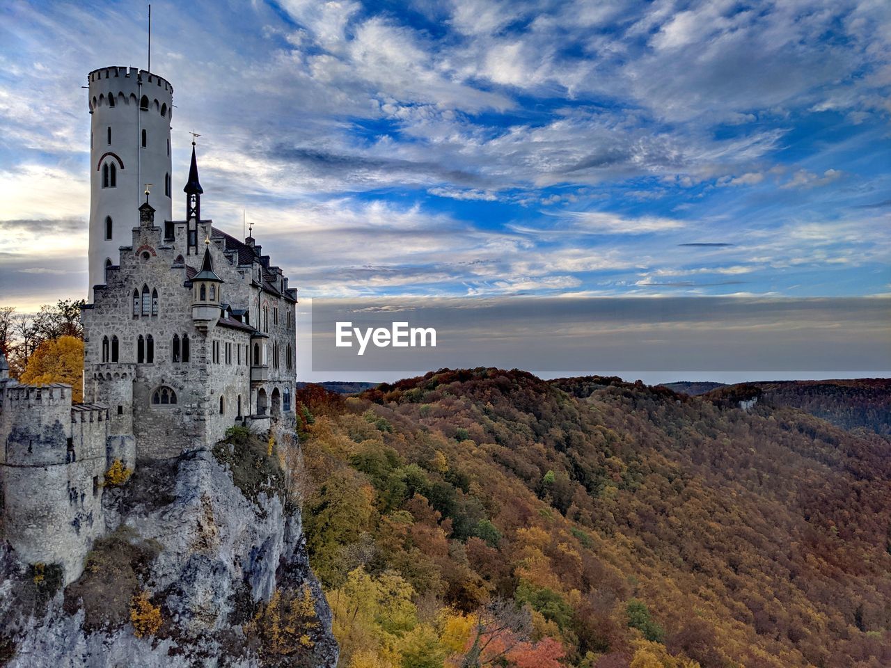 Castle by building against sky