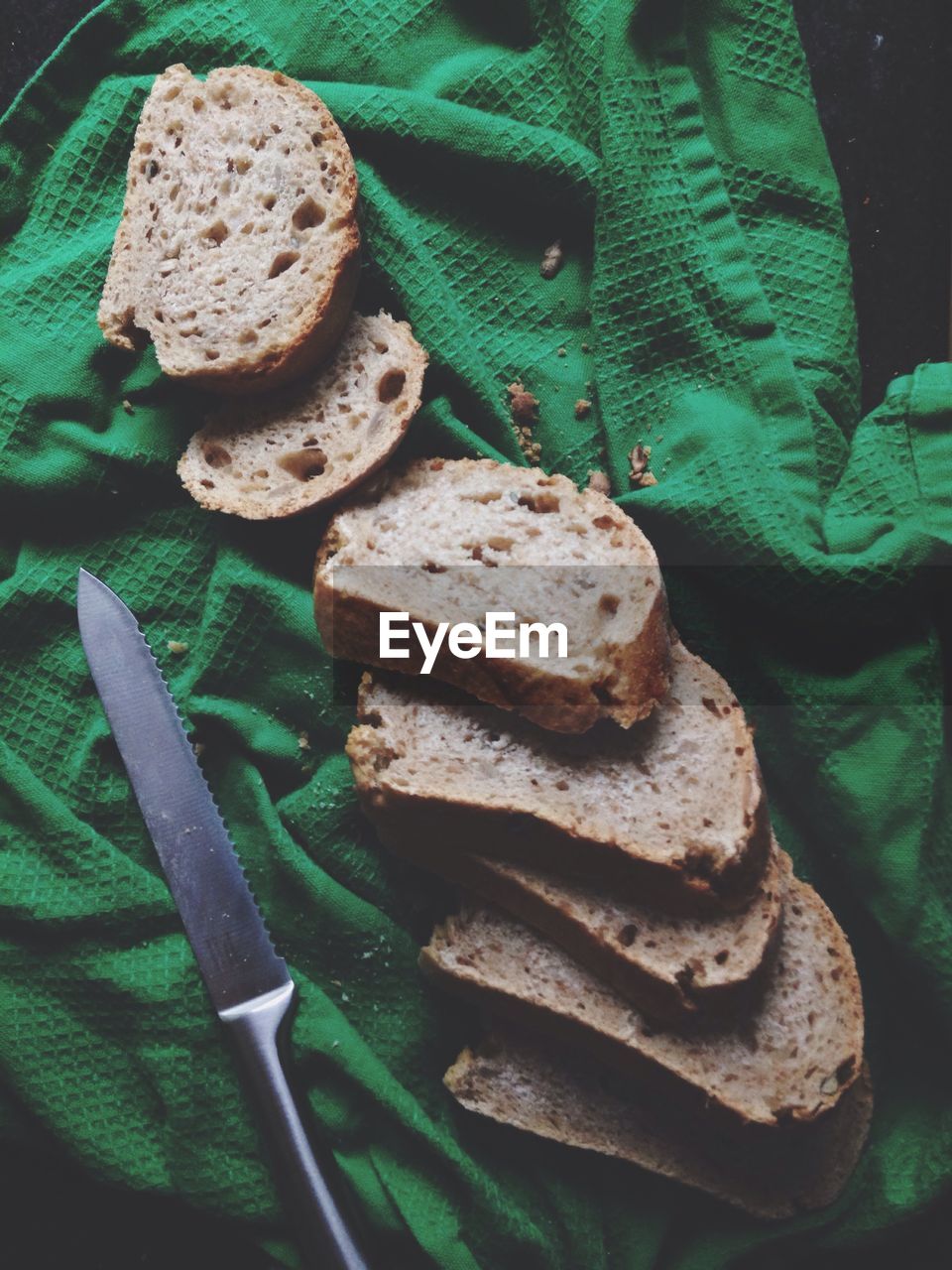 Close-up of breads on green fabric