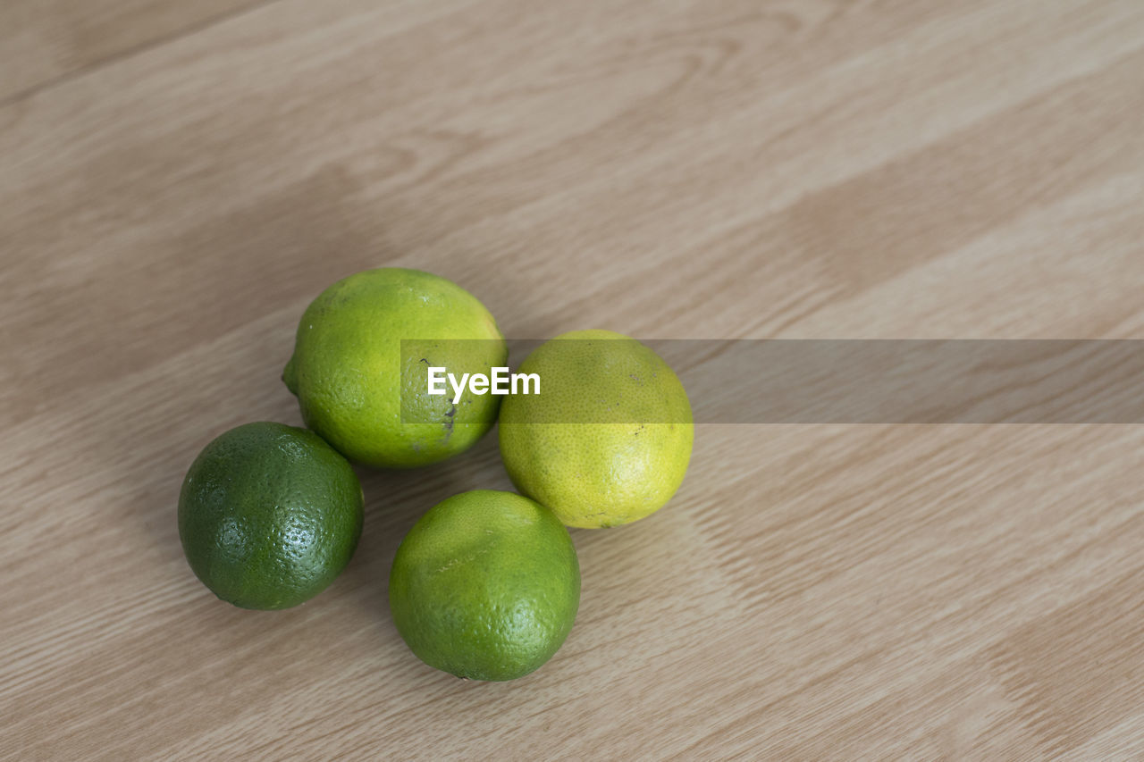 CLOSE-UP OF FRUITS ON WOODEN TABLE