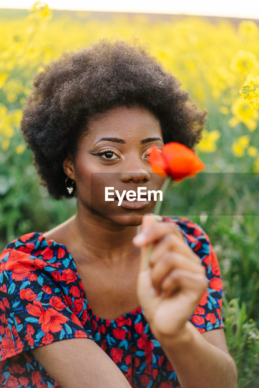 Positive beautiful afro girl on yellow field