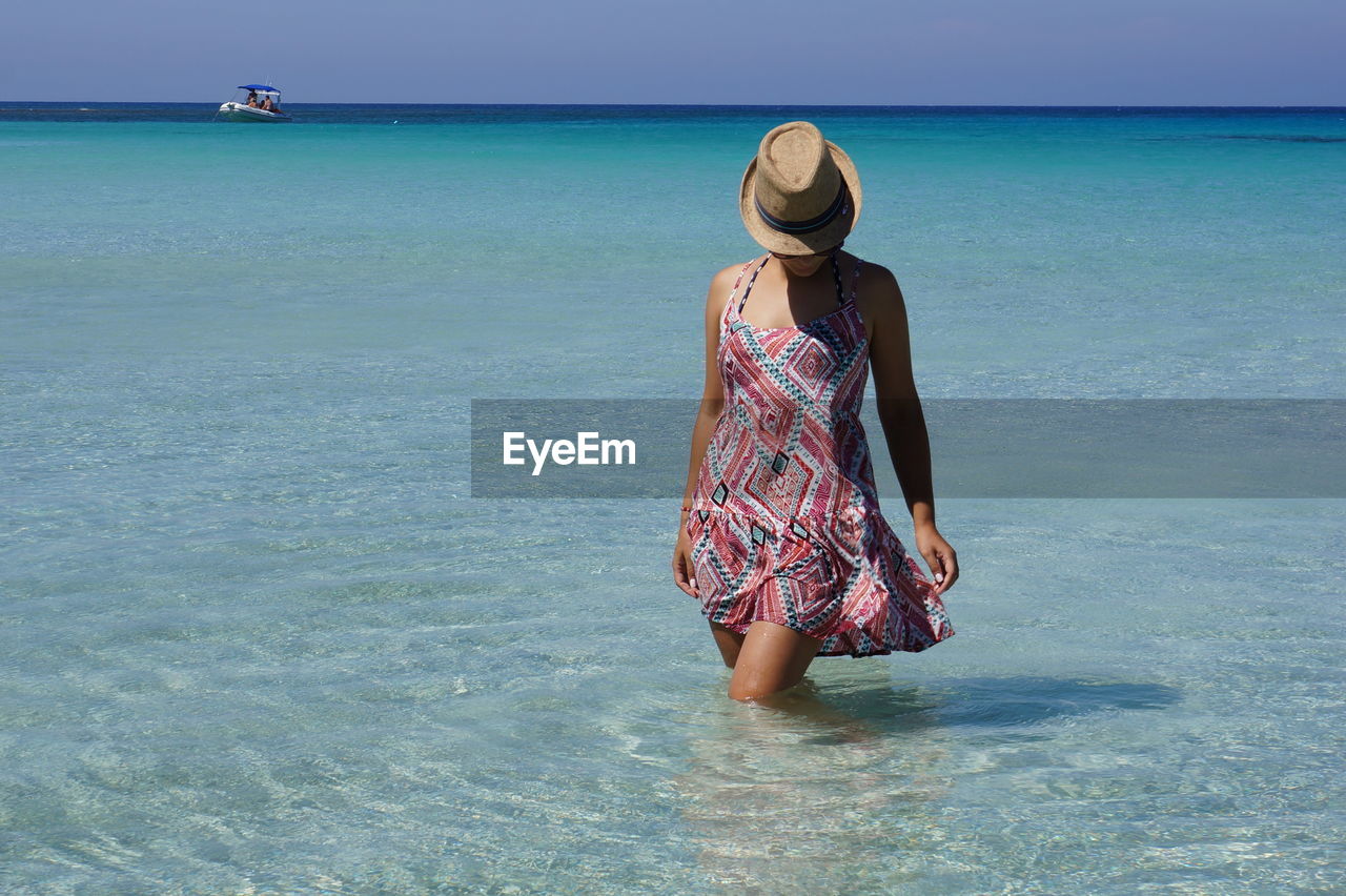 WOMAN WITH UMBRELLA ON BEACH